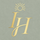Gold monogram with a sun design on a light gray background